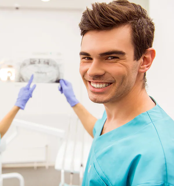 Smiling Las Vegas orthodontist reviewing a dental x-ray