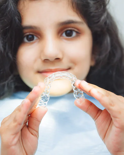 Teen smiling with Invisalign clear aligners