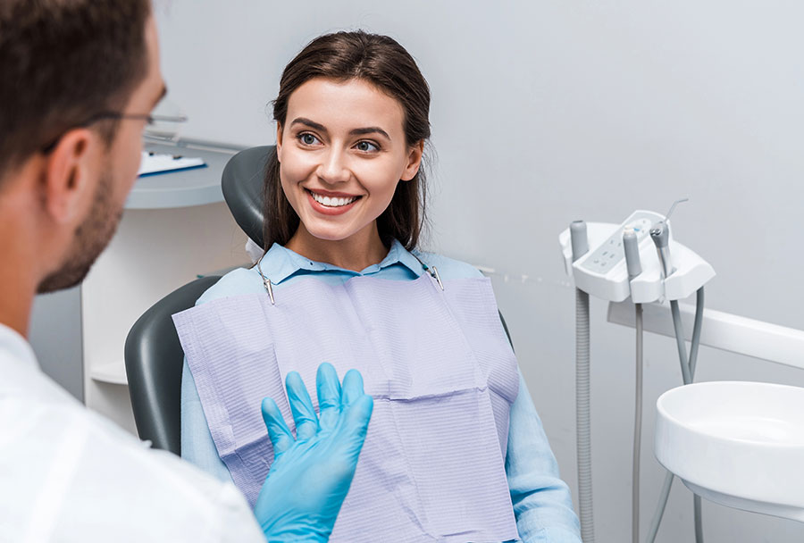 Smiling woman seated at orthodontic consultation